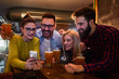 © lordn - Friends in Pub drinking Beer and Looking at Smartphone
