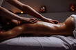 young Woman getting hot stone massage at spa salon