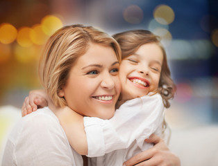 Wall Mural - happy mother and little daughter hugging