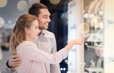 Wall Mural - couple looking to shopping window at jewelry store