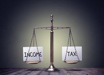 Income tax balancing finance books scales concept