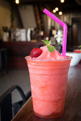 Wall Mural - Strawberry smoothies in plastic cup. Refreshment healthy drink. Diet drink. Indoor and cafe view with dark vignette.