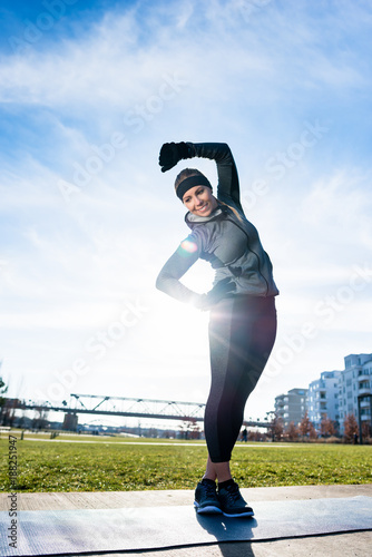 Athletic Young Woman Practicing Stretching Exercise While Standing With Crossed Legs Outdoors In A Sunny Day In The Park Buy This Stock Photo And Explore Similar Images At Adobe Stock adobe stock