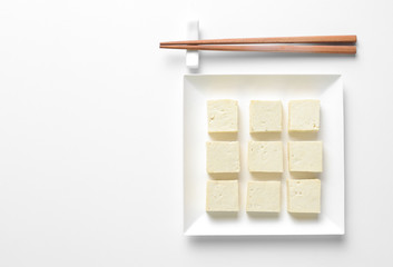 Wall Mural - Tofu diced and served in a square plate, concept table setting