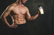 © denis_vermenko - Handsome athletic fitness man holding a shaker and posing gym