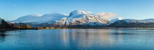 Landscape View Of Scotland And Ben Nevis Near Fort William In Winter With Snow Capped Mountains And Calm Blue Sky And Water