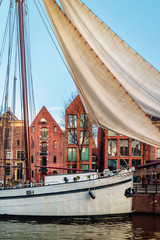 Wall Mural - Old sailboat in a canal in the city center of Groningen