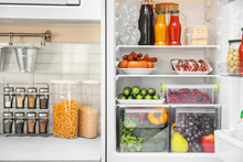 Refrigerator With Different Products In Kitchen