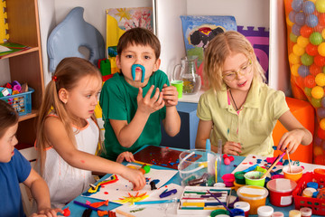 Wall Mural - Child dough play in school. Plasticine for children. mold from plasticine in kindergarten. Kids knead modeling clay with hands in preschool. Newcomer in children's team.