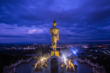Golden Buddha Standing On A Mountain At Sunset Twilight  In Nan Province, Thailand.