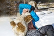 © boryanam - Woman playing with dog on the snow.Love dogs