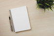 © samrit - Empty white notebook top view with pen on wooden table