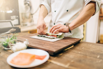 Male cook making seafood, asian kitchen