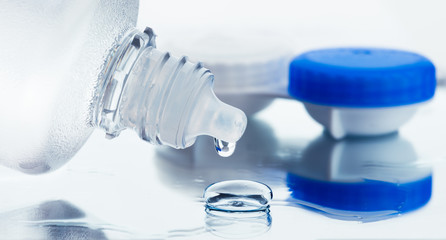 Canvas Print - Bottle with lens solution and case on table