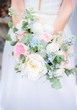 Rich colorful wedding bouquet in bride's hands