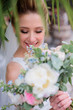 Rich colorful wedding bouquet in bride's hands