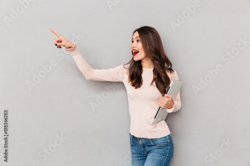 Half Turn Photo Of Charming Woman With Long Brown Hair Holding