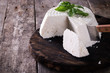 A fresh ricotta with basil leaf on wooden table italian food concept