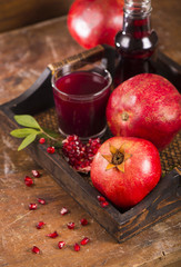 Sticker - pomegranate juice on a wooden background