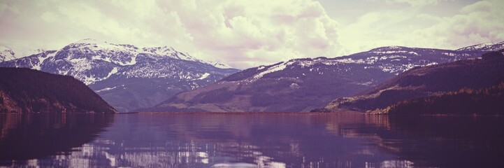 Poster - Composite image of snowcapped mountains and a lake 