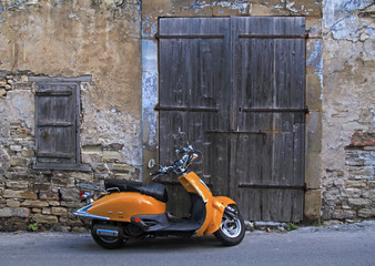 Sticker - street in old village with wood door and old scooter