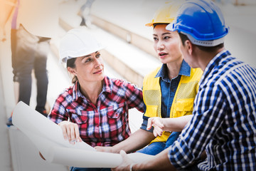 Wall Mural - Engineers man and woman working on plan building construction in city