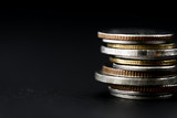Fototapeta  - Closeup of coins stack isolated on black background