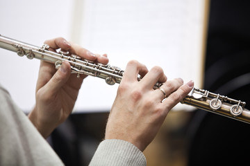 Wall Mural - Detail of a musician flute in his hands closeup 