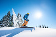 Low angle and full length shot of a skier on top of the mountain enjoying beautiful sunny winter day copyspace active people living leisure hobby extreme slope snow seasonal sport
