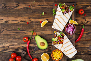 Mexican tacos with beef in tomato sauce and avocado salsa. Flat lay. Top view