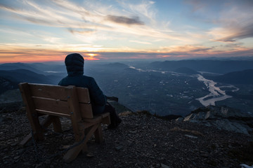 Wall Mural - Adventurous man on top of the mountain during a vibrant sunset. Taken on Cheam Peak, near Chilliwack, East of Vancouver, British Columbia, Canada.