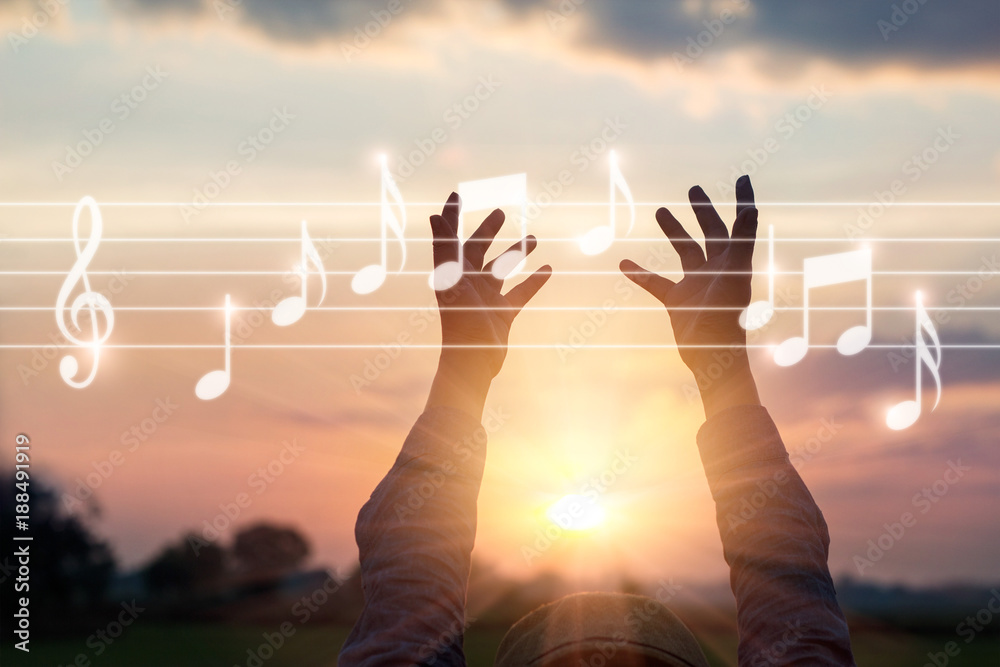 Abstract woman hands touching music notes on sunset nature background, music concept - obrazy, fototapety, plakaty 