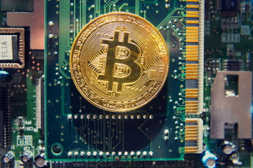 Wall Mural - golden bitcoin coin lying on green computer keyboard, cryptocurrency bubble investing concept