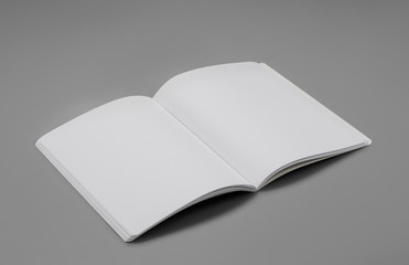 Wall Mural - Mock-up magazine, book or catalog on gray table. Blank page or notepad on solid background. Blank page or notepad for mockups or simulations.