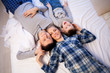 © dmitriisimakov - mom dad and son in the morning lying on the bed at home