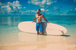 © Nejron Photo - Man with Stand Up Paddle Board on the beach in Bahamas.