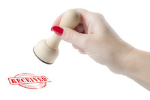 Hand Holding A Rubber Stamp With The Word Received