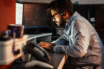Late at night, a dedicated  programmer works diligently, driven by determination and fueled by coffee, as he strives to meet project deadlines and embrace innovation.