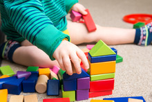 Child Playing With Building Blocks Learning New Skills