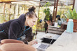 © Scandinav - Female gardener using laptop