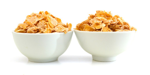 Wall Mural - Closeup of delicious cereals in white bowl on a white background