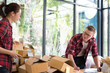 © 88studio - startup small business owner working with computer at workplace. freelance man & woman seller check product order, packing goods for delivery.  Online selling, e-commerce, shipping concept