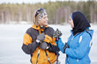 © Scandinav - Two female skiers talking outdoors