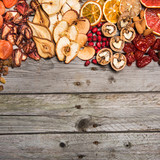Fototapeta Mapy - Different dried fruits on a wooden surface