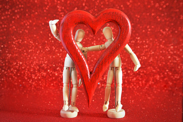 mannequins in love, playing with a wooden heart