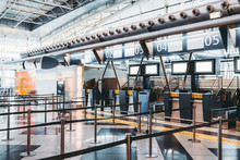 Modern Check-in Zone Of Airport: Luggage Accept Terminals With Baggage Handling Belt Conveyor Systems, Numerous Empty Information LCD Screen Mockups, Indexed Check-in Desks With Digits Above