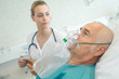 © auremar - close-up of senior man using oxygen mask in clinic