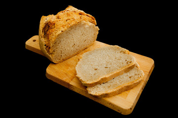 Sliced Bread on cutting table, black background