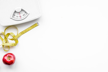 lose weight concept. scale and measuring tape on white background top view copy space