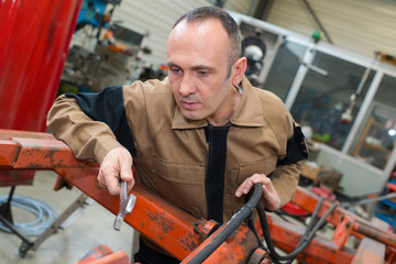 machinery mechanic with wrench